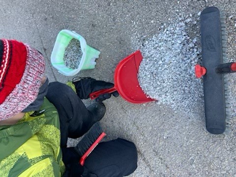 people sweeping up excess salt